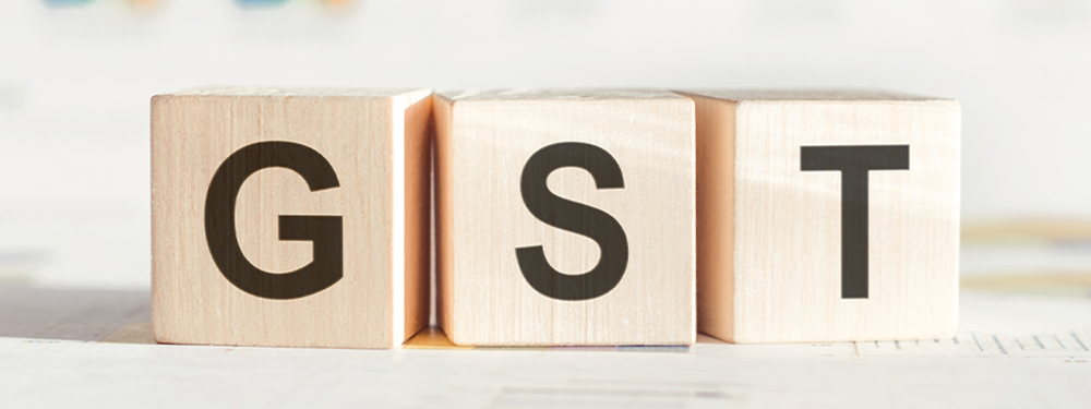 Wooden blocks spelling GST